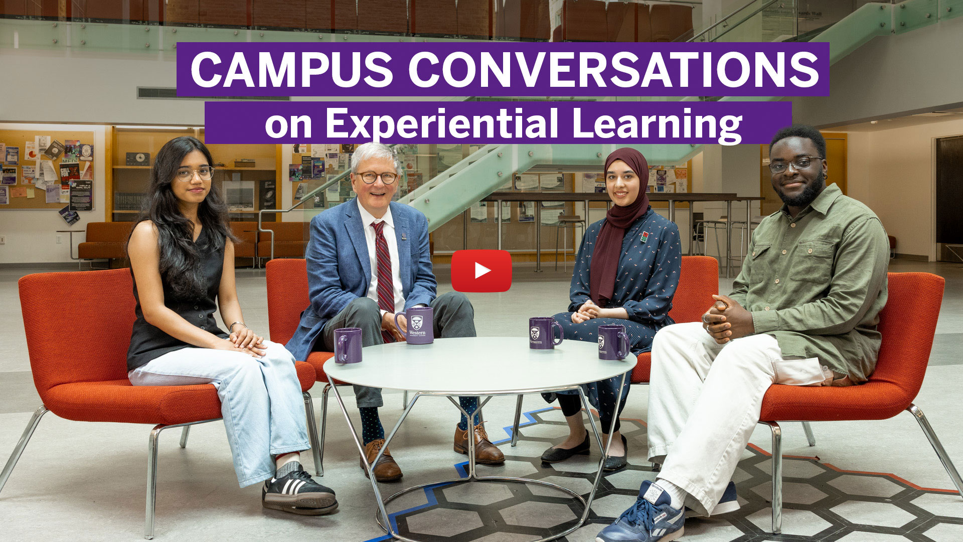 President Shepard sitting around a table with three students