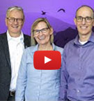 Alan Shepard with researchers and video play button